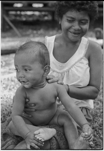 Smiling young woman and infant