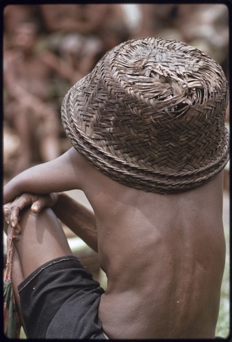 Mortuary ceremony: woman wearing empty basket over her head