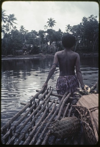 Kaiyabai'i pulls her canoe in shallow water to Tukwaukwa village, Kiriwina