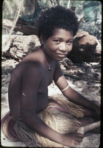 Adolescent girl wearing necklace and short fiber skirt