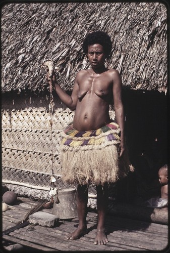 Kula ring: woman displays a red shell-disc necklace (soulava)