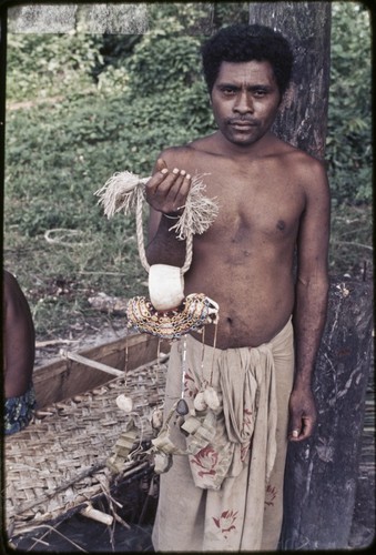 Kula ring: man displays white shell armband (mwali) — Calisphere