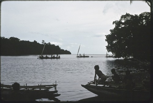 Fishing: canoes returning to inlet near Tukwaukwa, sails furled, children on beached canoes in foreground