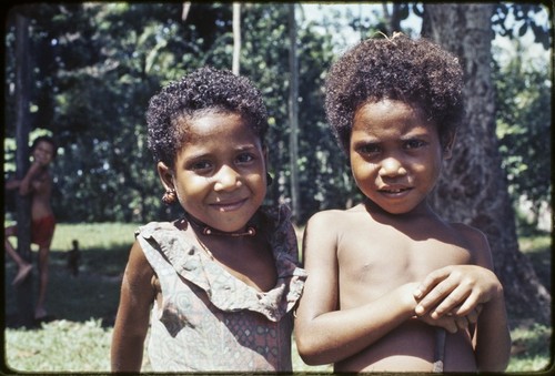 Children, girl (l) wears turtle shell earrings and shell necklace