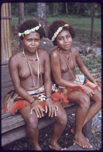 Adolescent girls wearing colorful short fiber skirts, flower garlands, and mourning necklaces