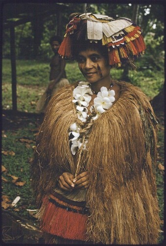 New mother wears long fiber shawl, flower garland, and skirt valuable on top of her head