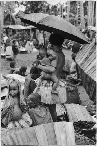 Mortuary ceremony, Omarakana: women and children at exchange of banana leaf bundles