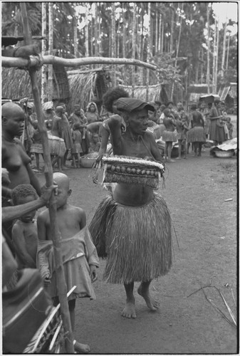 Mortuary ceremony, Omarakana: mourning woman carries decorated basket of a deceased relative