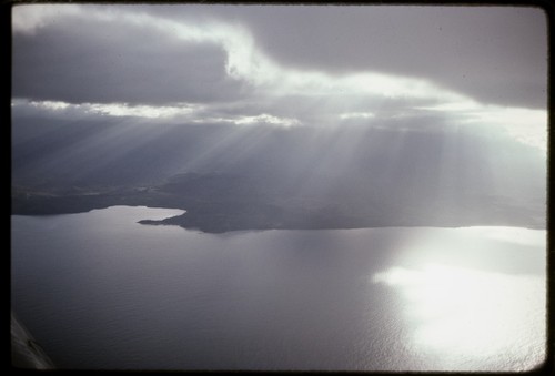 Milne Bay, aerial view of unidentified coastline, small bay, and hills