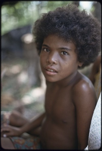 Child gazes at photographer with calm expression