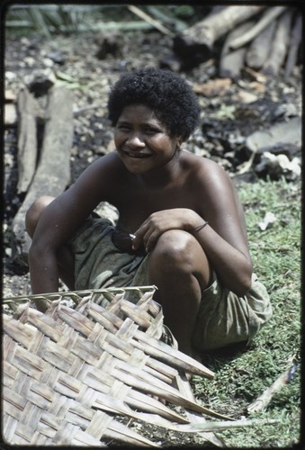 Weaving: Kitemwalusa makes a loosely-woven basket from coconut fronds