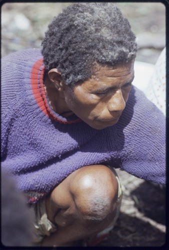 Western Highlands: woman reaching for food