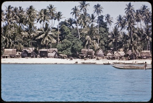 Kaileuna Island: Kaduaga village houses, canoes and beach