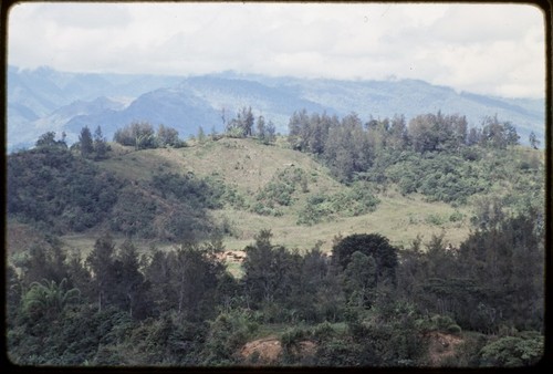 Western Highlands: mountains, trail descending a hillside, a few houses visible on ridge