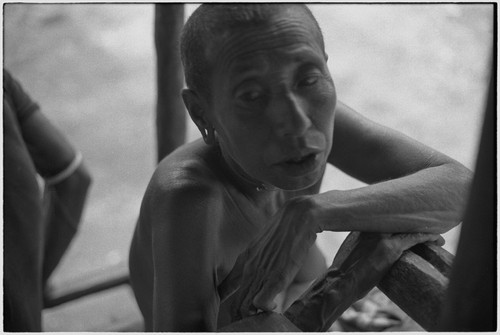 Older woman relaxing on a house veranda