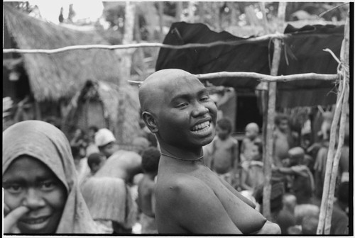 Mortuary ceremony, Omarakana: smiling woman, her face blackened with ash and head shaved to signify mourning