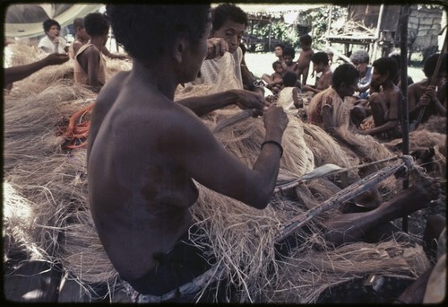 Mortuary ceremony: women weave long banana fiber skirts for exchange