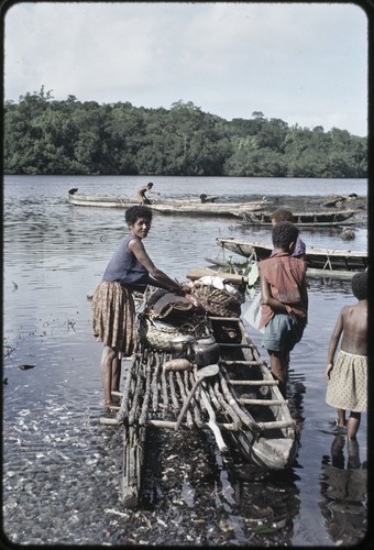 Canoes: women load items onto canoe used for coastal transport