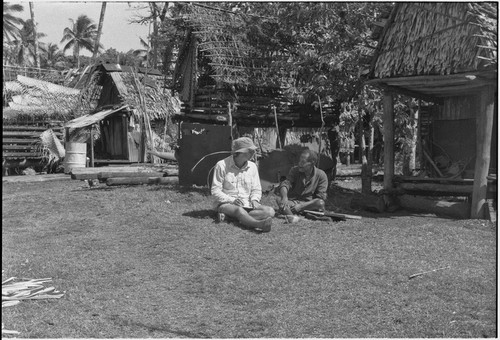 Anthropologist Edwin Hutchins talks with M'lapokala, elevated yam house in background