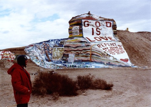 Slab City: photograph of Salvation Mountain with artist Leonard Knight