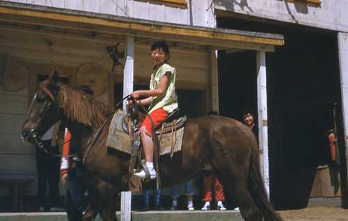 Young girl riding horse