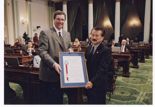 George Nakano presenting Assembly Resolution to Kevin Shelley