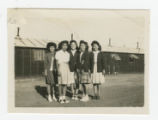 Nisei women standing outside a barrack