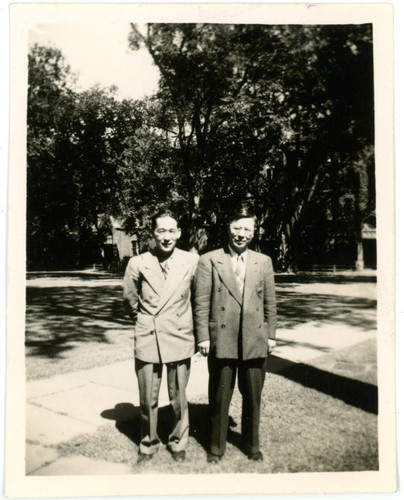 Mervyn Suzuki standing next to man