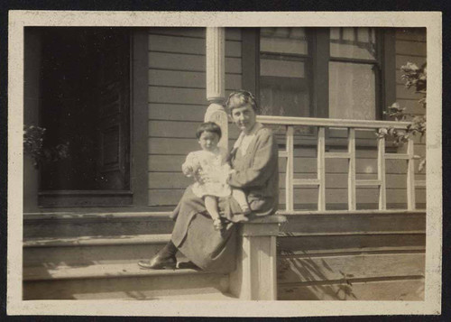 Woman and young girl on porch