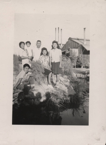 Group gathered at a Japanese garden pond at Poston incarceration camp