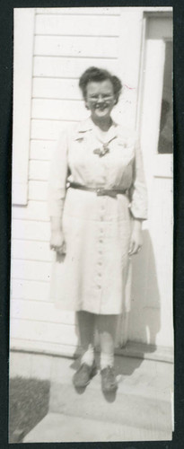 Photograph of Martha Shoaf in front of staff housing at Manzanar