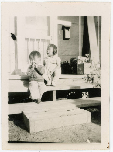 Young children sitting on stairs at incarceration camp