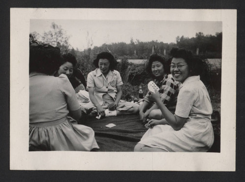 Women playing cards outdoors at Jerome incarceration camp