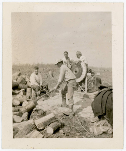 Men cutting wood at incarceration camp