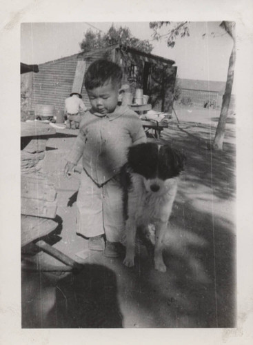 Boy and dog at Poston incarceration camp