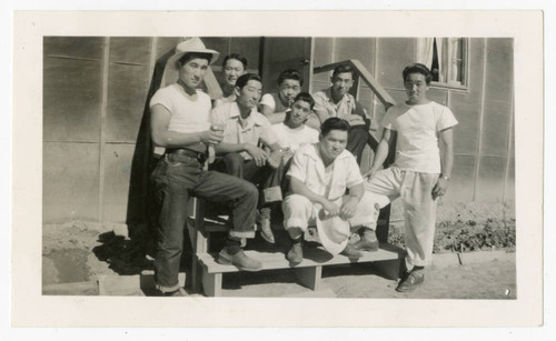 Satoru Maeda with workers outside barrack at Heart Mountain