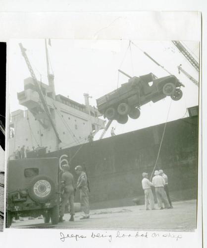 Jeeps being loaded on ship