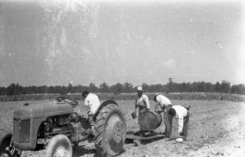 Men in field with tractor