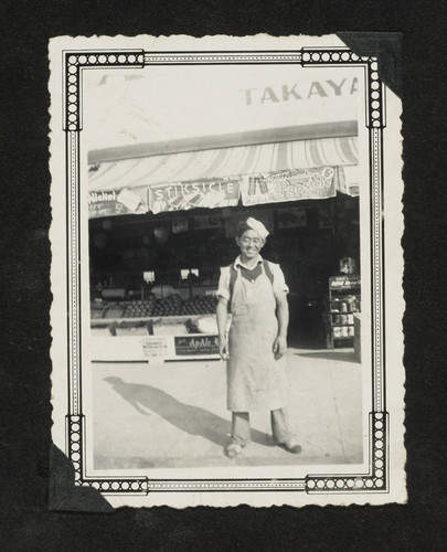 Man in front of fruit stand