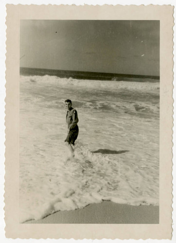Man in military uniform standing in ocean