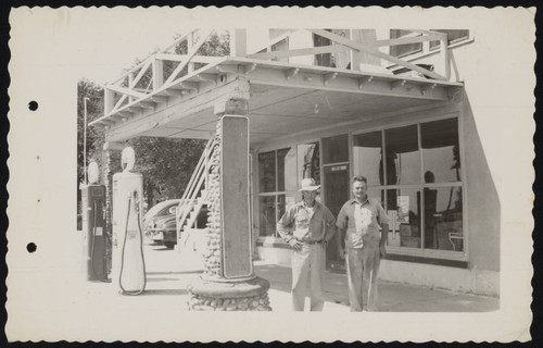 Men in front of a building at gas station