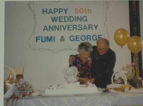 Fumi and George Matsuura cutting cake at their 50th anniversary party