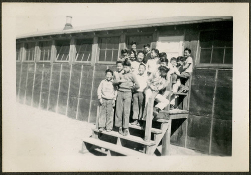 Group of male children on barrack stairs