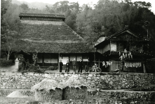 [Group photo in front of buildings]