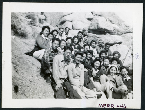 Photograph of a group of people sitting on rocks in the Sierra Nevada