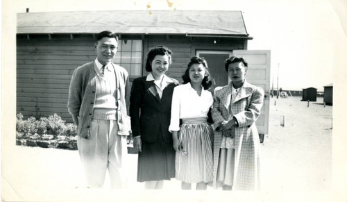 [Group photo in front of barracks]