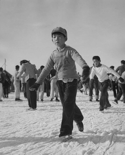 [Young former California boy learning to ice skate at Heart Mountain incarceration camp]