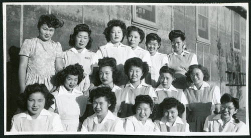 Photograph of hospital staff aides posing in front of the Manzanar hospital