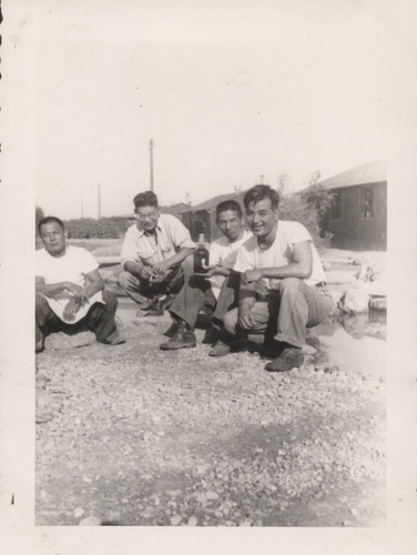 Four men sitting in semi-circle at Poston incarceration camp