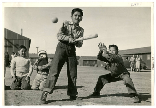 Photograph of several boys playing baseball at Manzanar on February 10, 1943